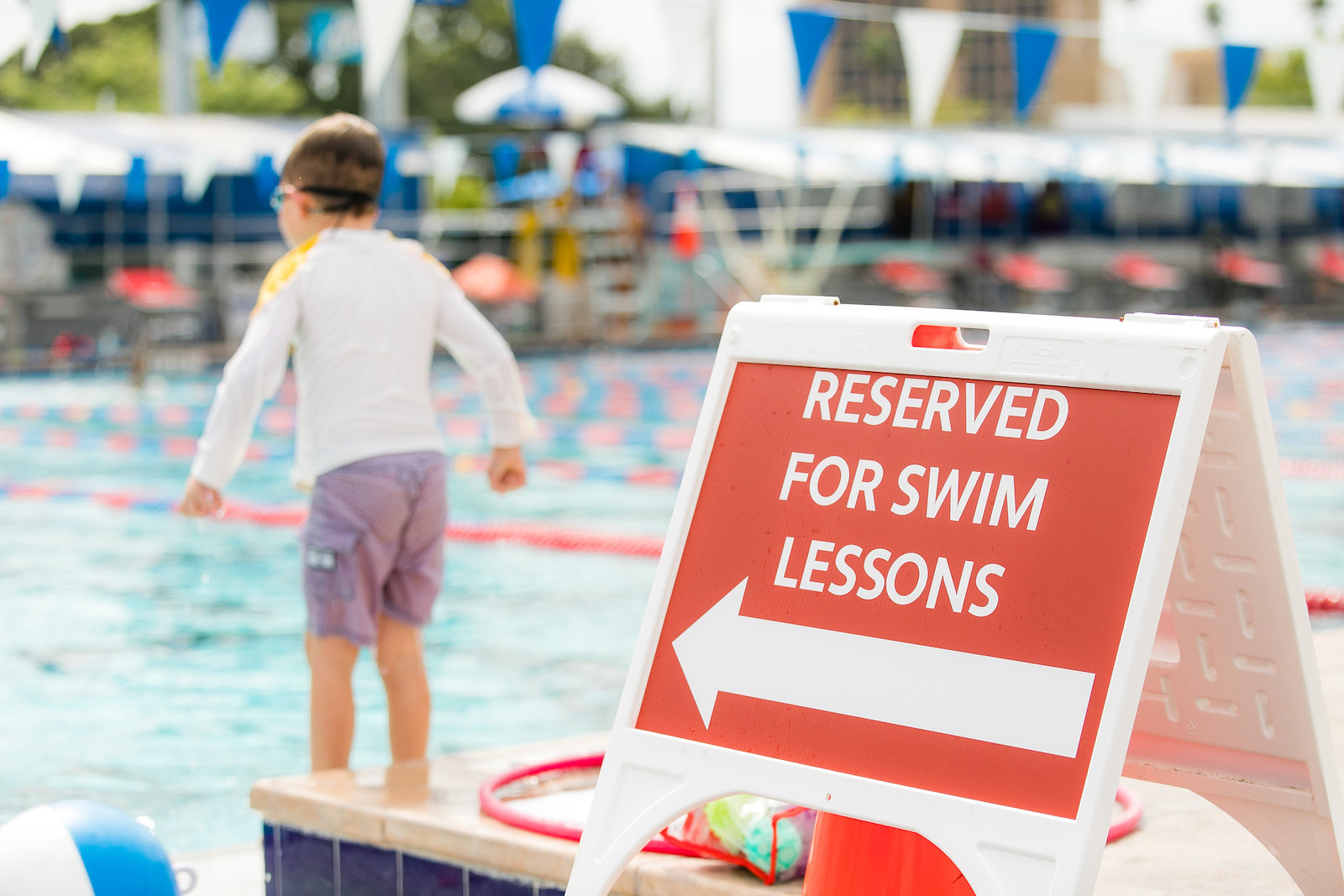 recreation pool with sign that says reserved for swim lessons